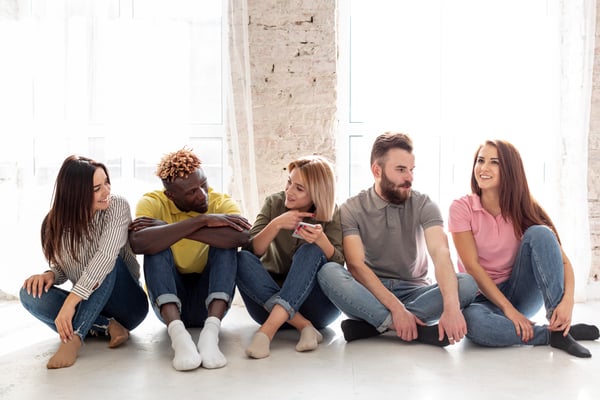 group-young-friends-sitting-floor
